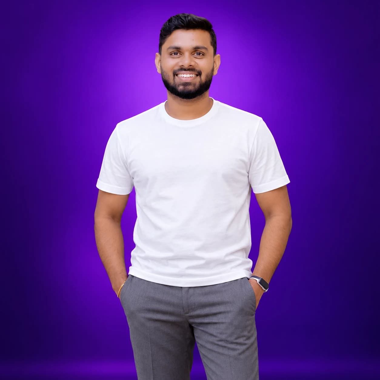 Sakith smiling in a white t-shirt against a purple backdrop